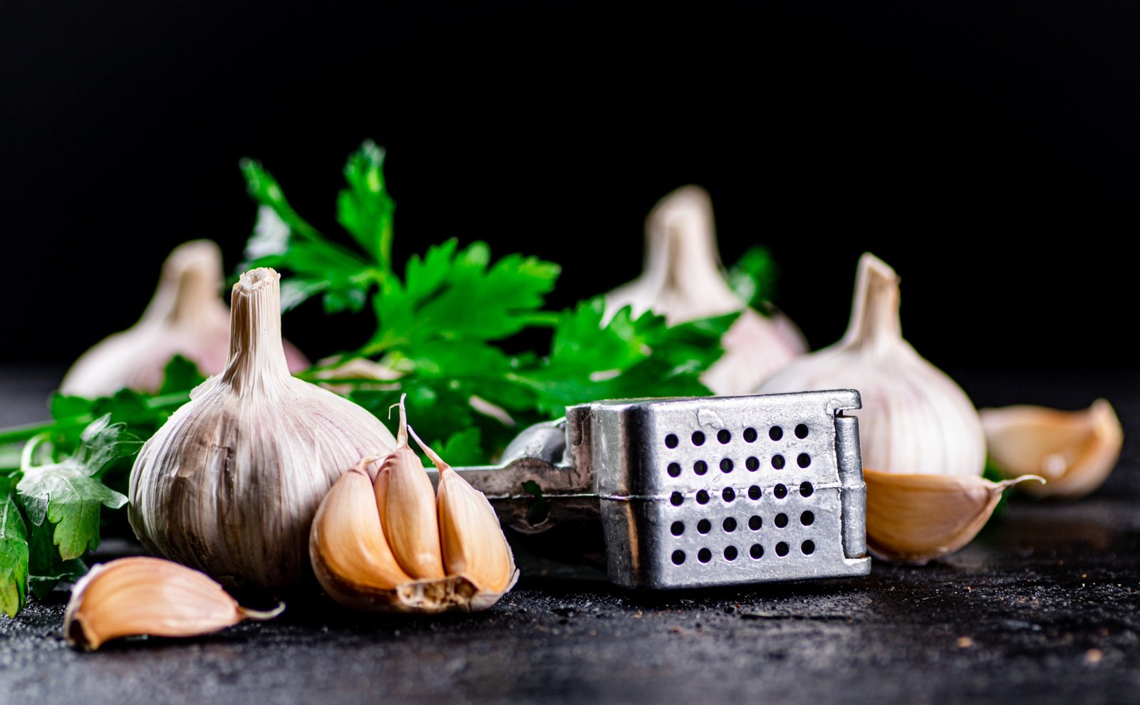 Garlic with parsley and garlic press.